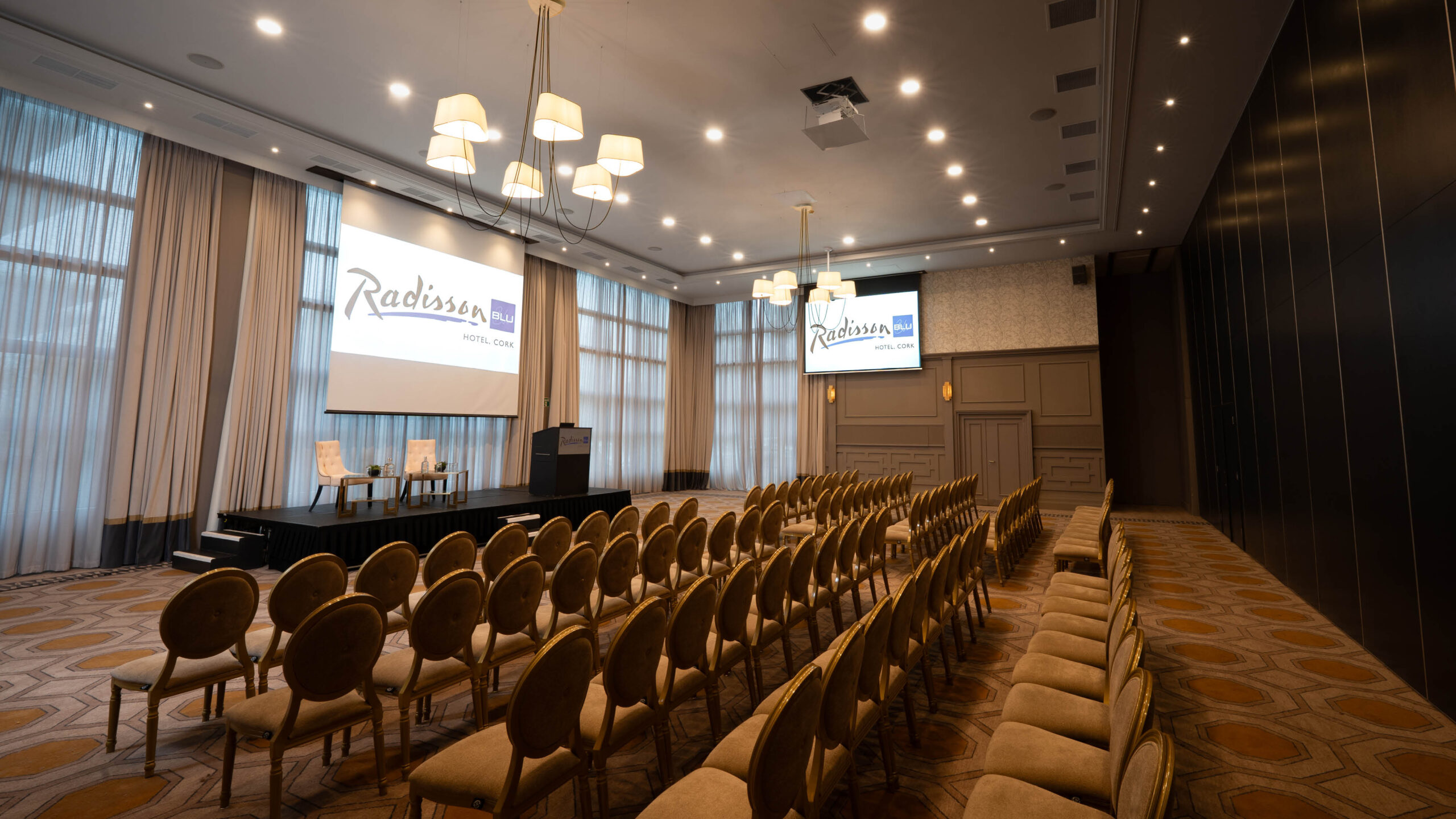 Conference and meeting room at Radisson Blu Hotel Cork with stage and presentation screens